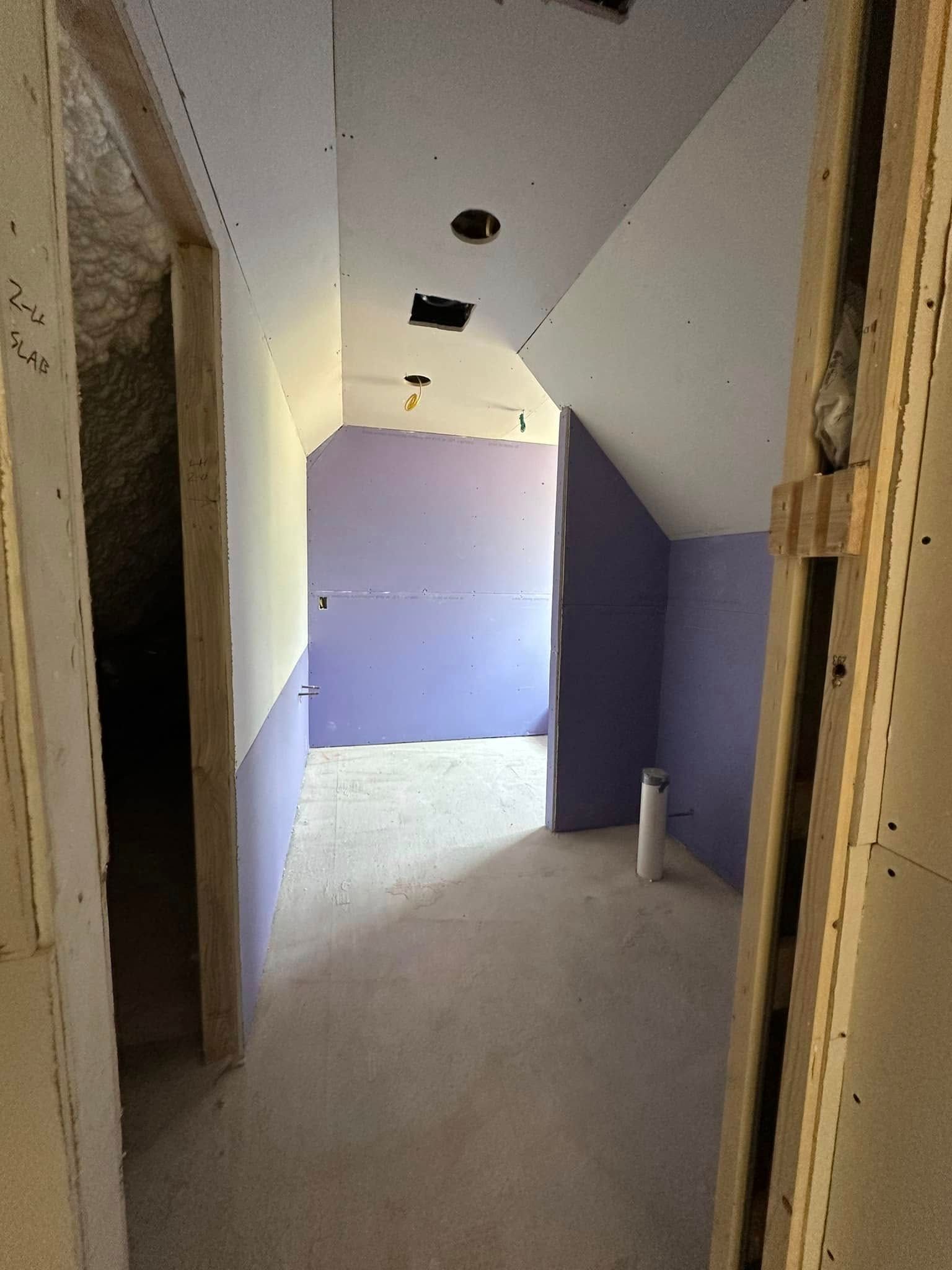 A hallway with purple walls and a white ceiling