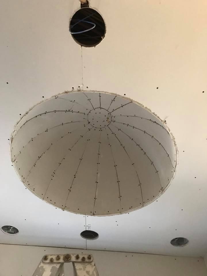 A large circular object is hanging from the ceiling of a room.