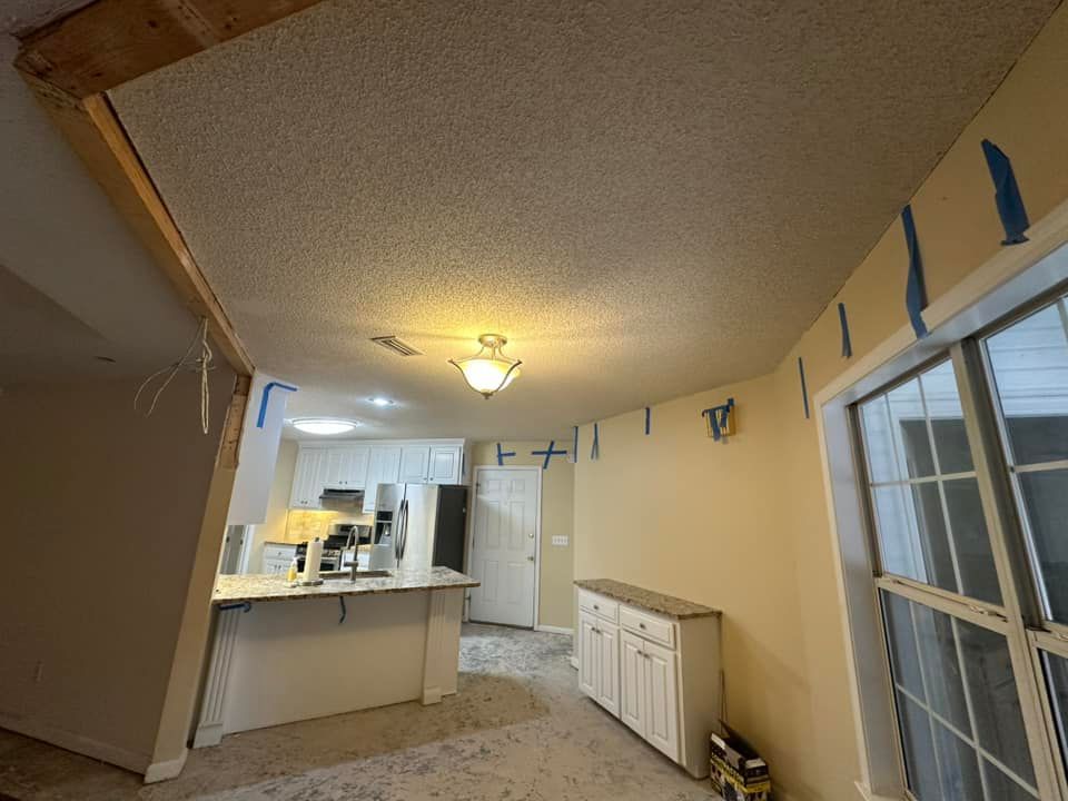 A living room with a ceiling that is being remodeled.