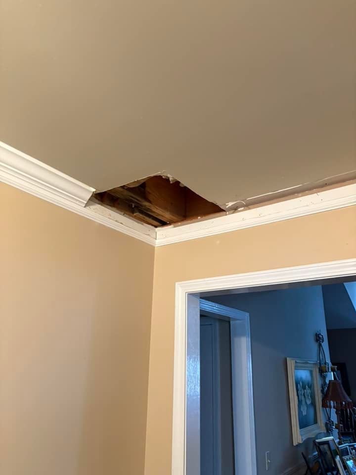 There is a hole in the ceiling in a room.