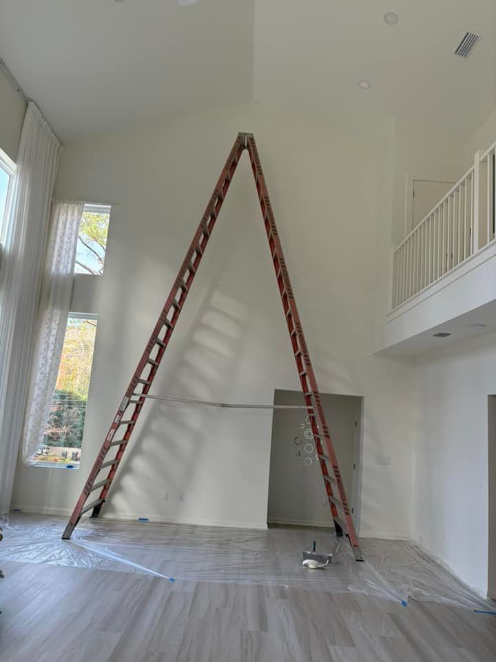 A ladder is leaning against a wall in an empty room.