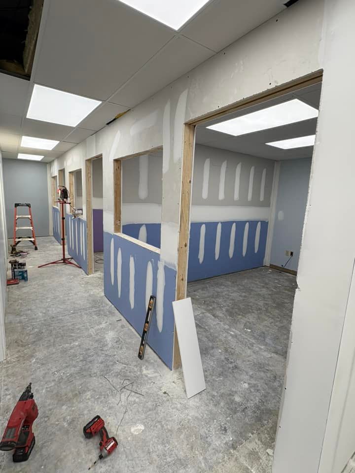 A room is being remodeled with drywall and a ladder.