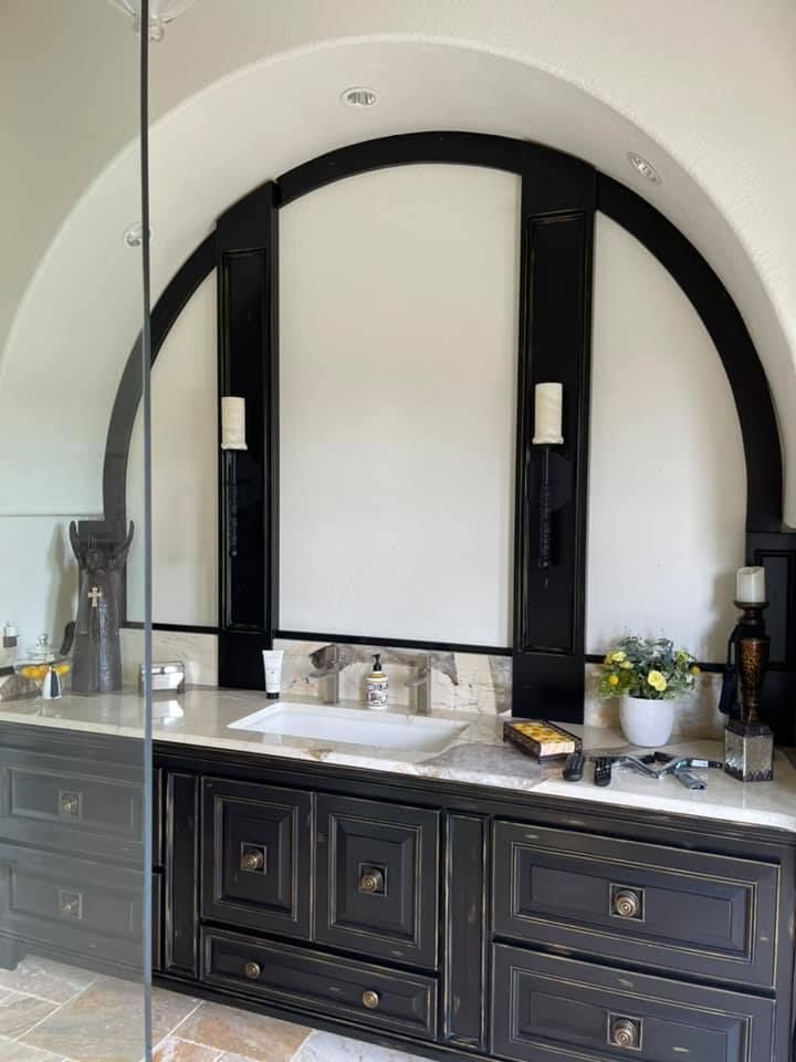 A bathroom with a sink and a walk in shower.