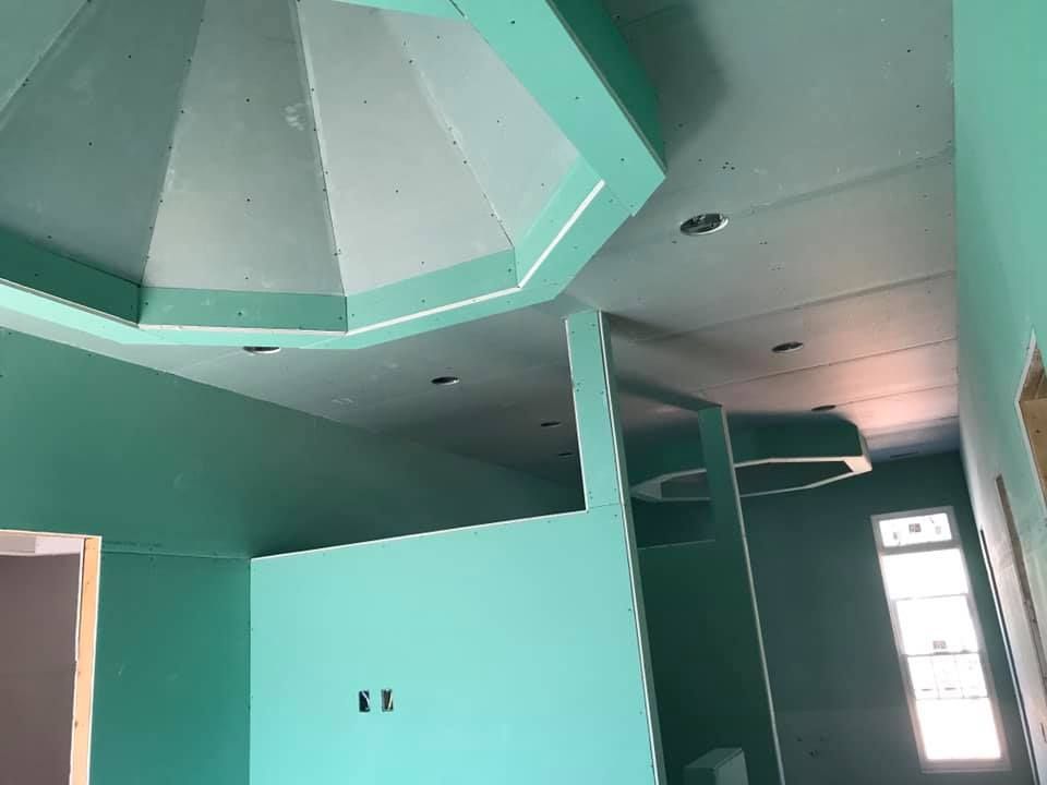 A room with green walls and a ceiling that looks like a dome.