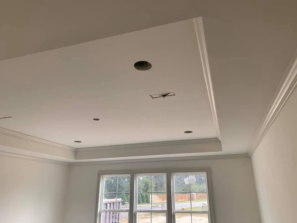 A room with a ceiling that is very high and a lot of windows.