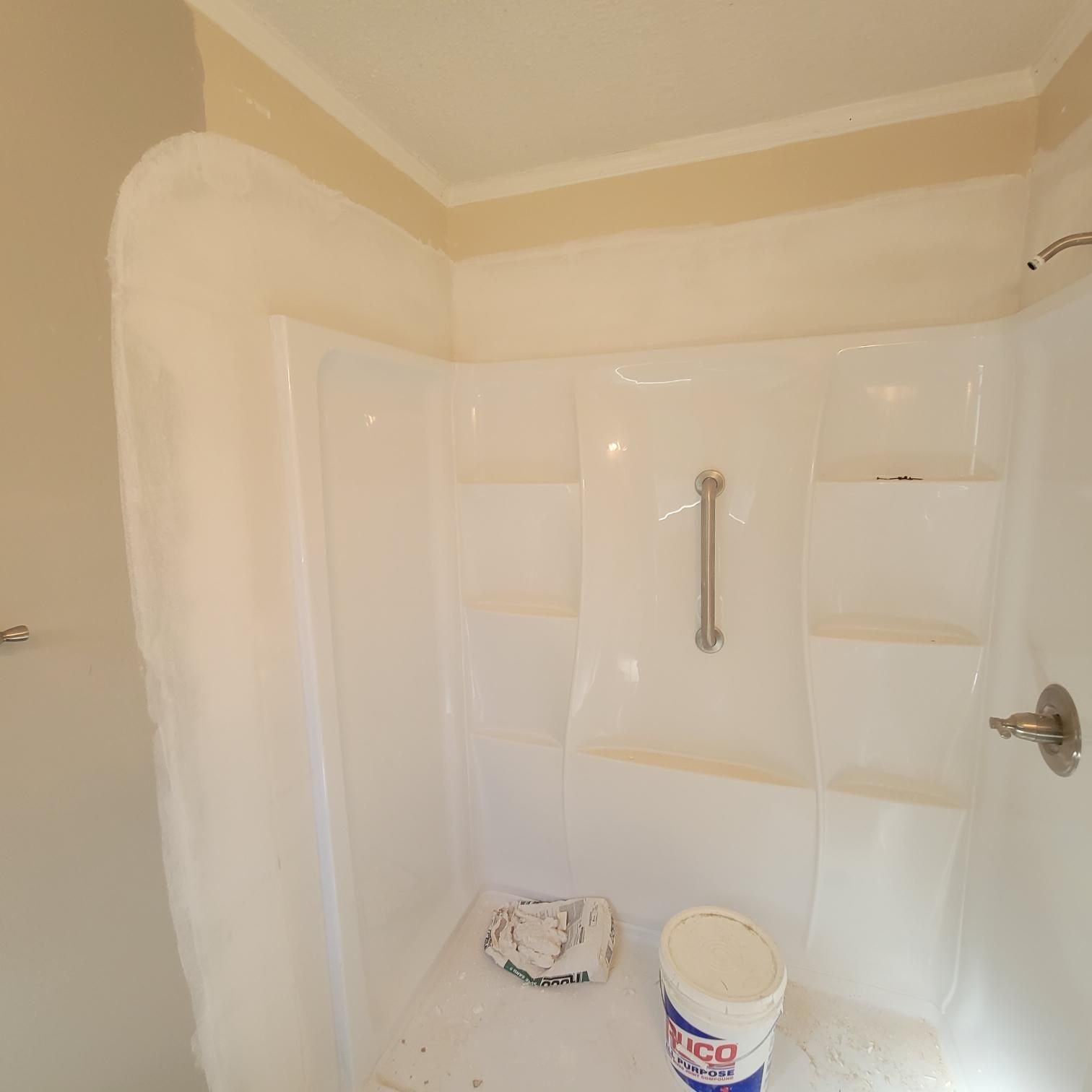 A bathroom with a bucket that says asco on it