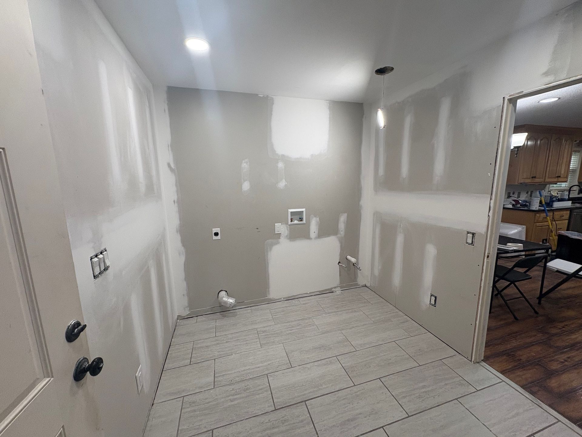 A bathroom with a shower and a ceiling that is being painted.