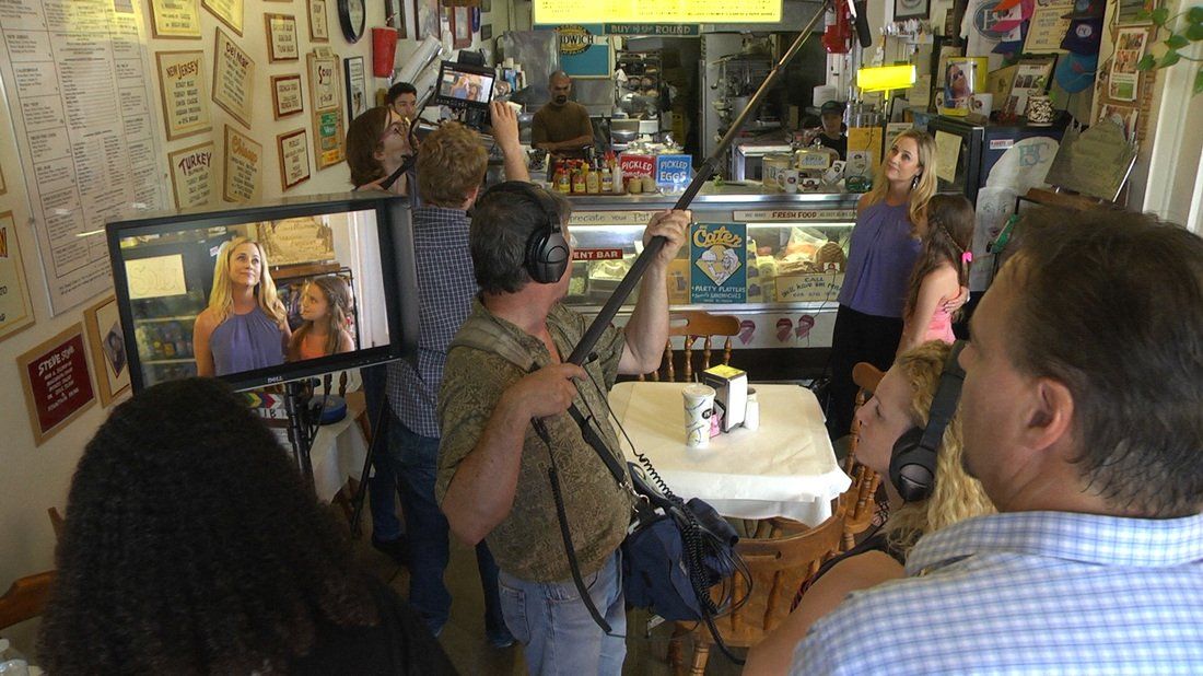 actors and film crew filming a scene for a movie