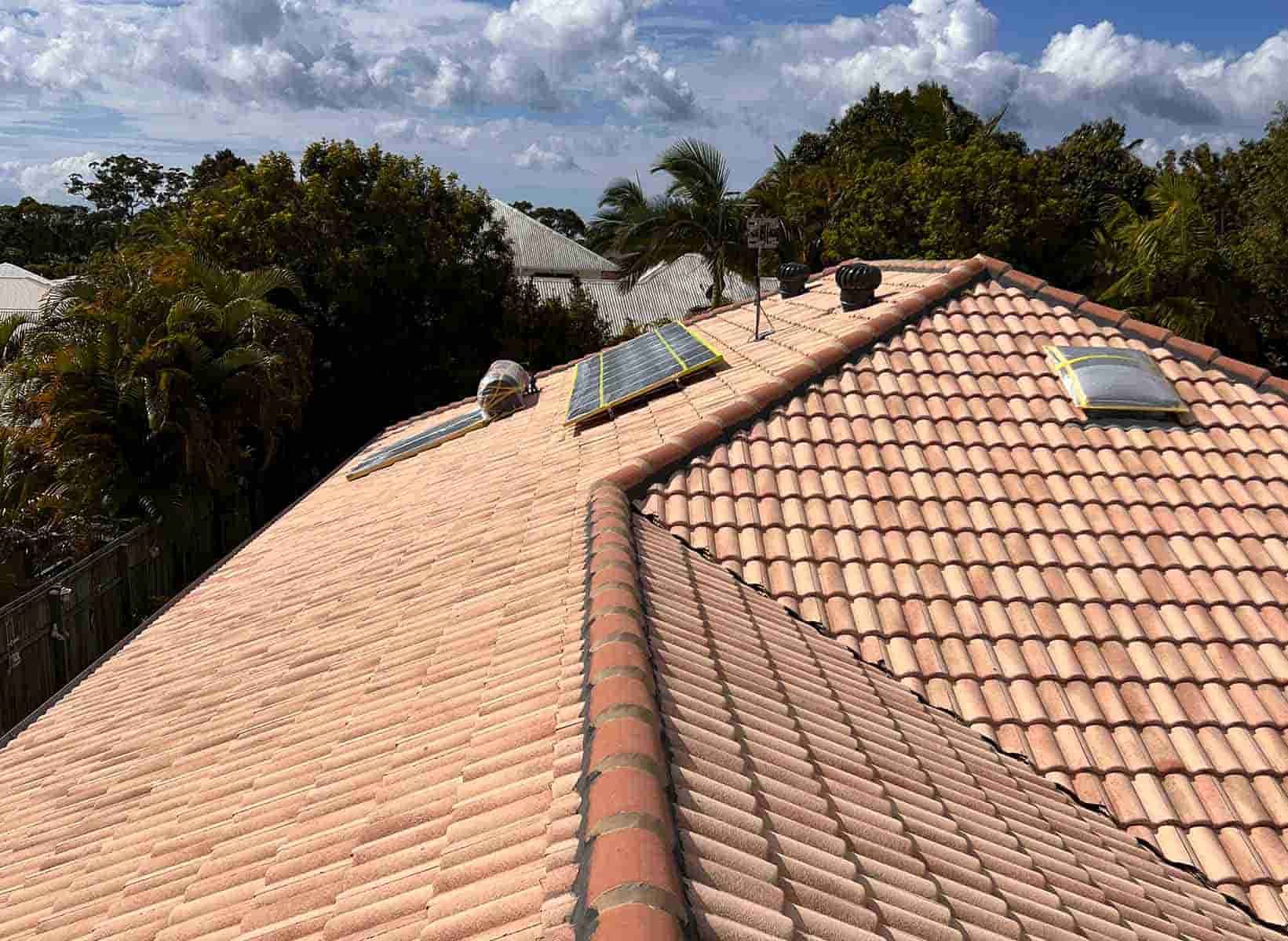 A Tiled Roof Of A House With A Skylight — House & Roof Painting & Restorations In Maroochydore, QLD