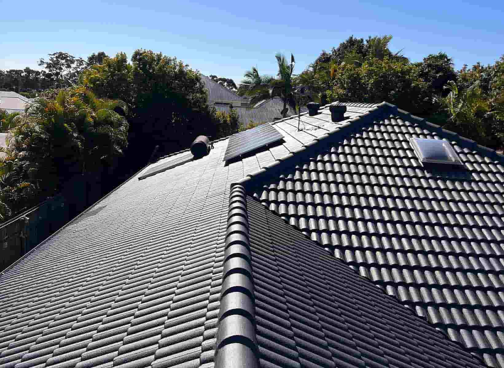 The Roof Of A House With A Tiled Roof And Trees In The Background — House & Roof Painting & Restorations In Maroochydore, QLD