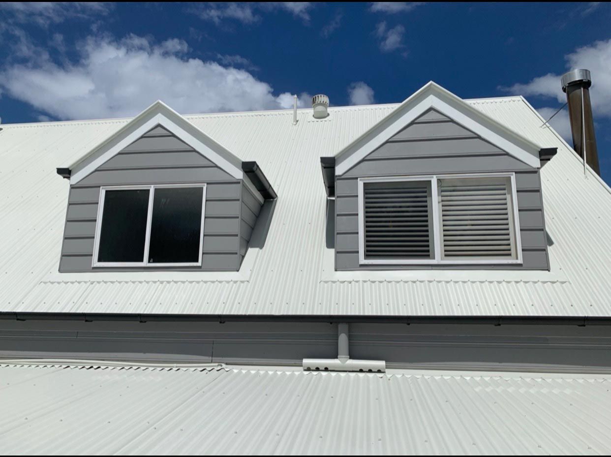 A House With A White Roof And Two Windows — House & Roof Painting & Restorations In Maroochydore, QLD