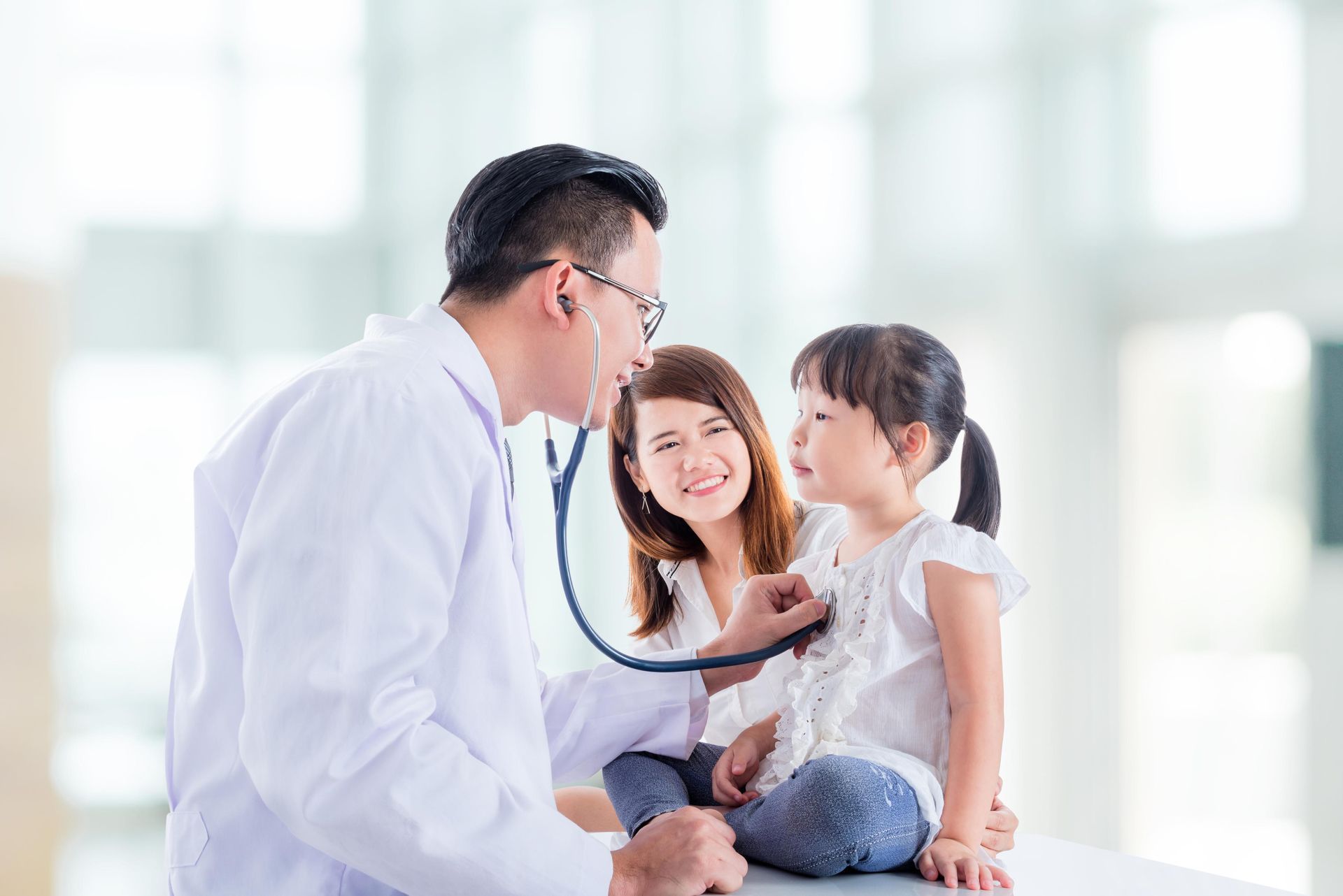 Pediatrician examining a child, listening to their heartbeat with a stethoscope