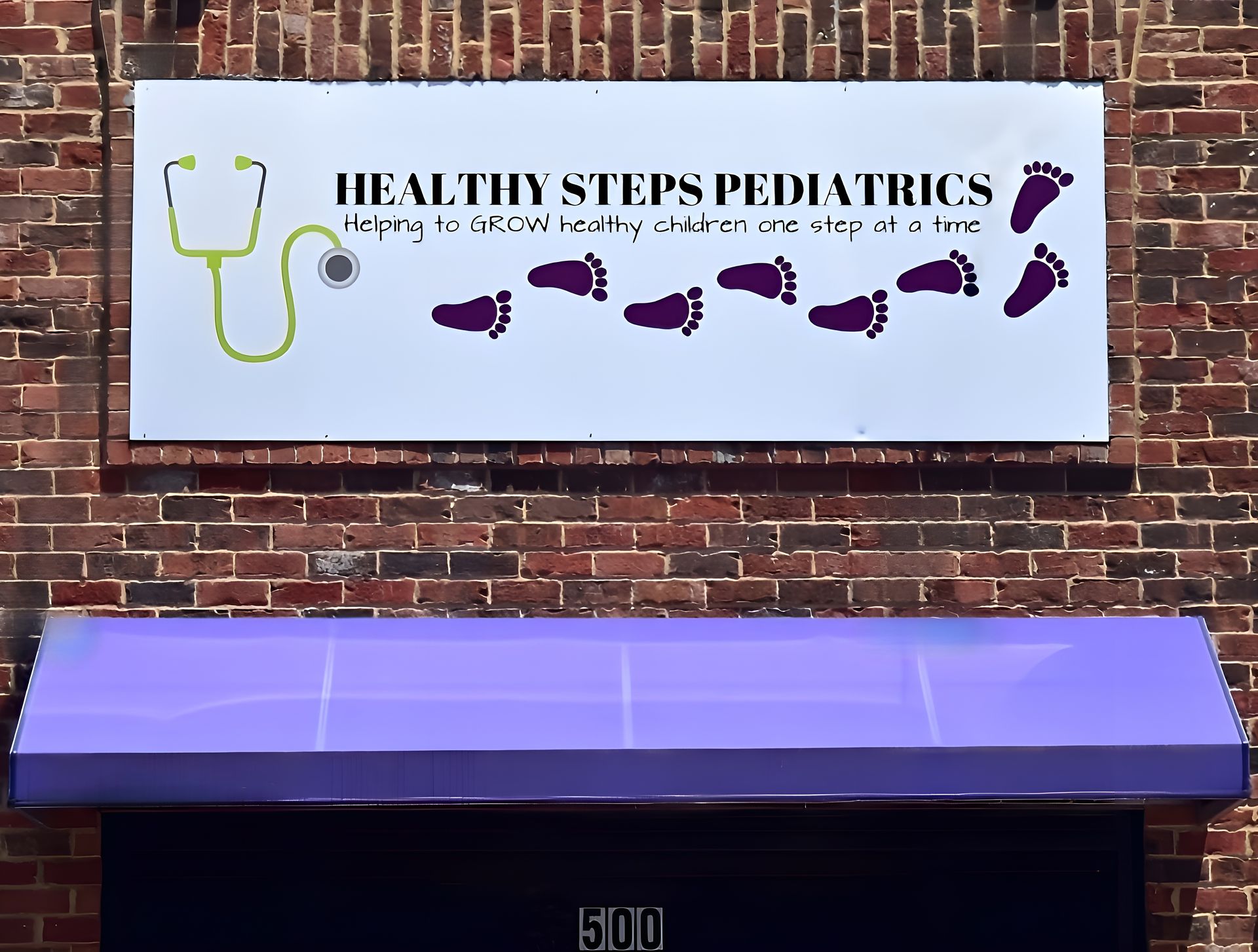 A brick building with a sign that says healthy steps pediatrics