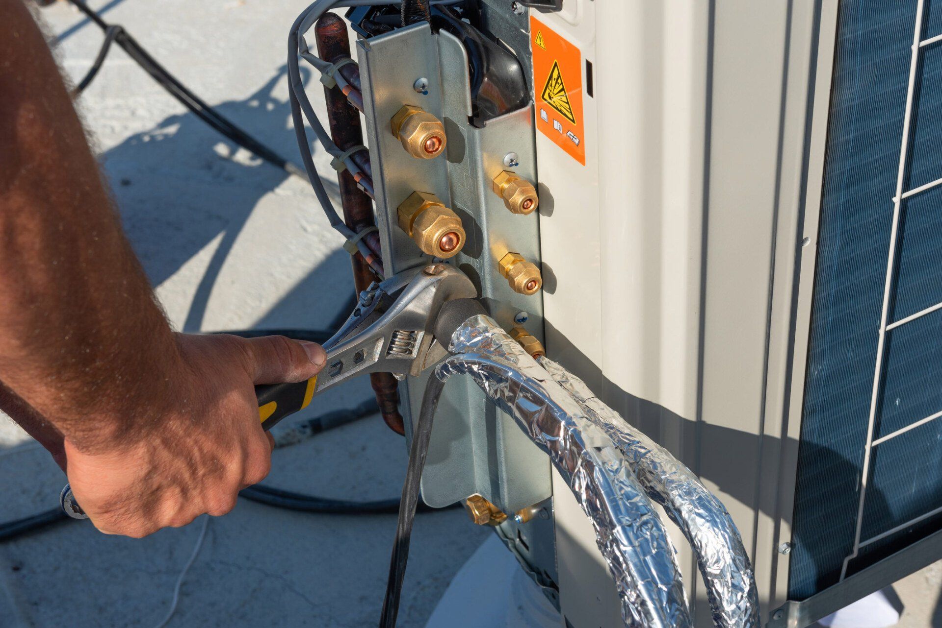 Man Using Wrench to Tighten Unit of Air Condition — Summerville, SC — Carolina Air Care