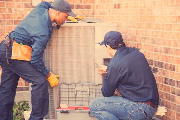HVAC contractors installing a new air conditioner.
