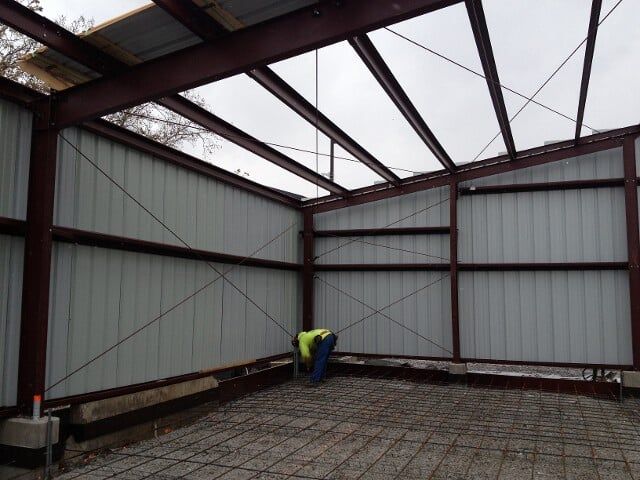 man fixing iron sheet wall - Constructions in New Castle, PA