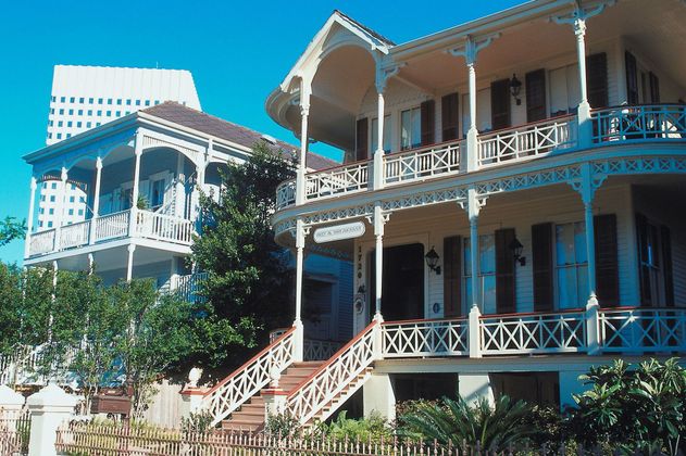Two rocking chairs on the porch of a house .