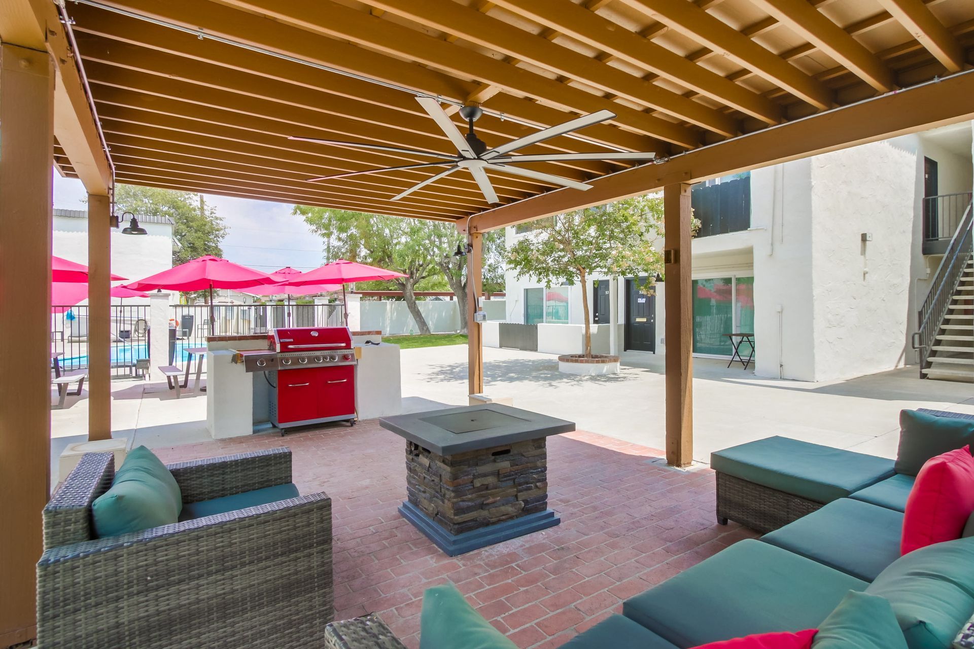 Photo showing outdoor lounge area featuring seating and a barbecue grill
