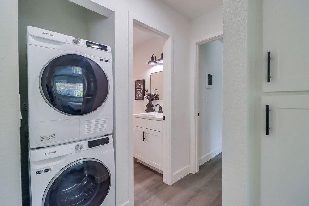 Photo showing the hallway, with the washer and dryer area in the foreground