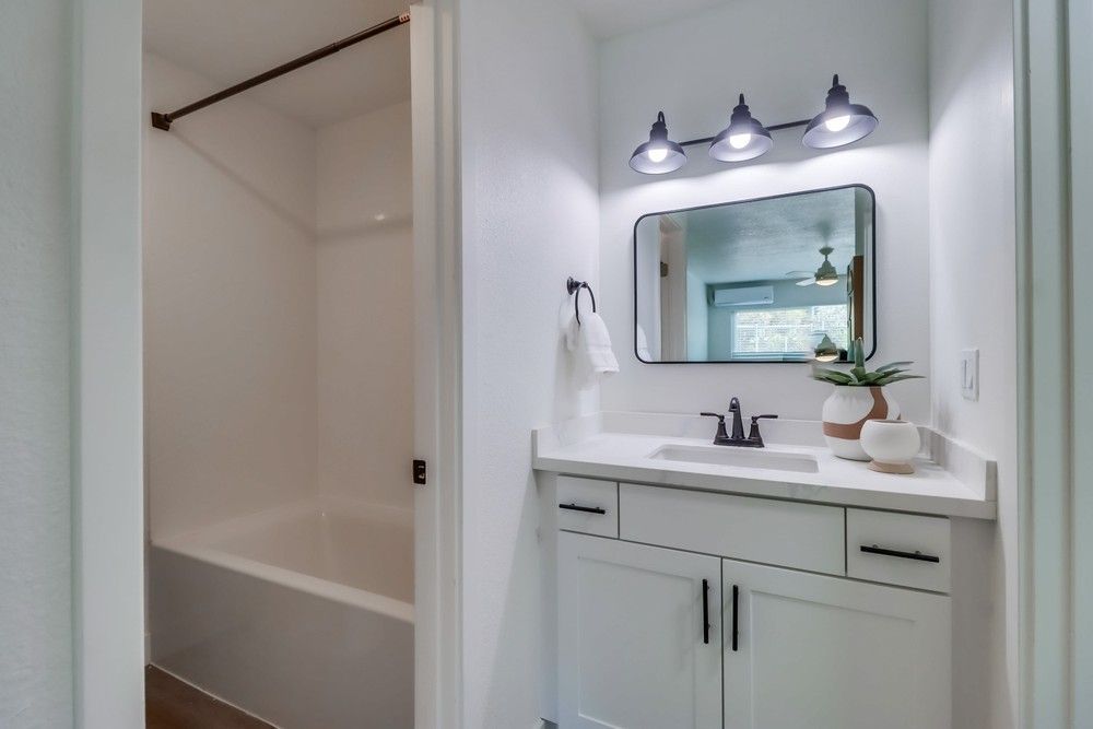 Photo showing a bathroom separated in a different entrance from the sink, and the bathroom has a shower/tub combo