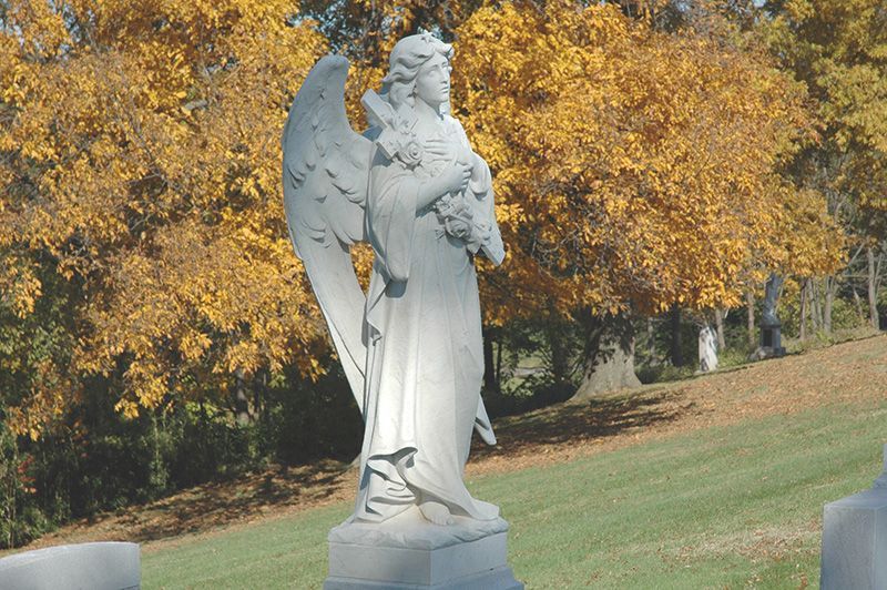 a statue of an angel holding flowers in a cemetery KCA, KY