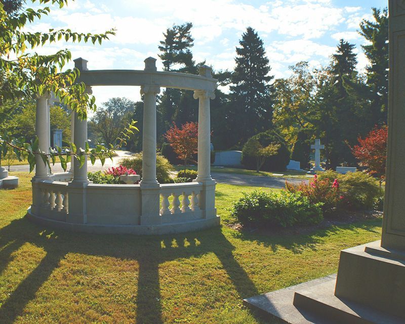 a gazebo in a cemetery with a cross in the background KCA, KY