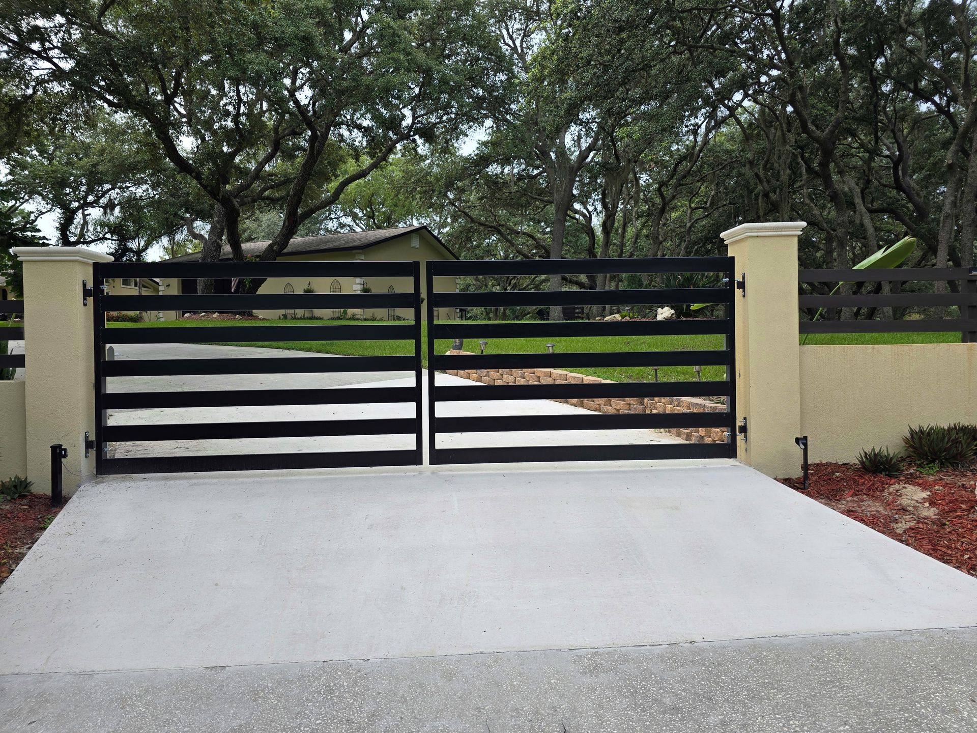 A white house with a black gate in front of it
