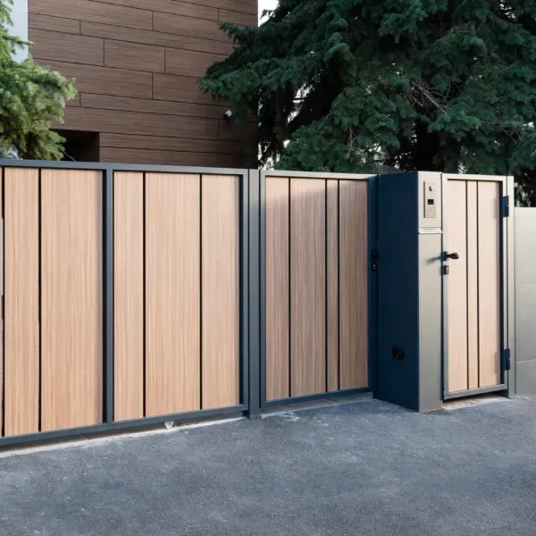 A wooden fence with a gate in front of a house