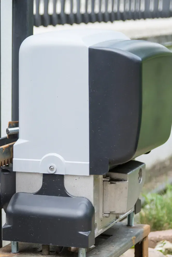 A sliding gate motor is sitting on top of a wooden table.