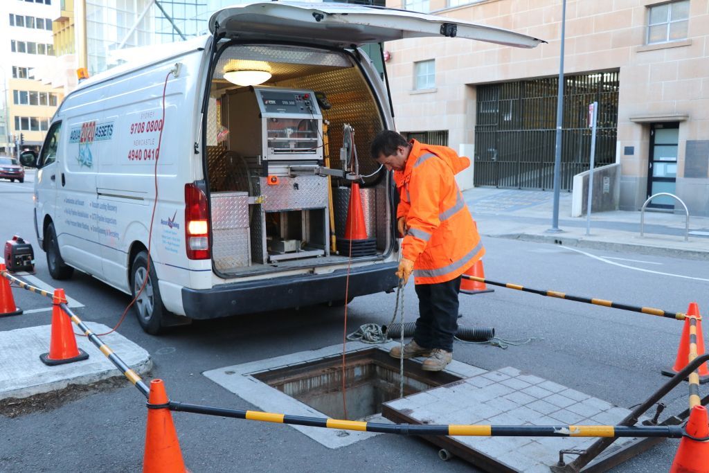 Lowering the CCTV Camera into position for a CCTV Pipeline Inspection.