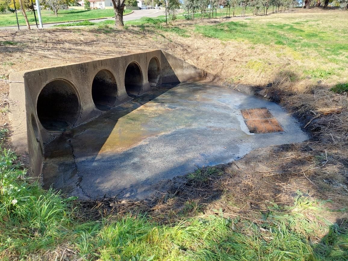 Recently cleaned industrial drains in a council park.
