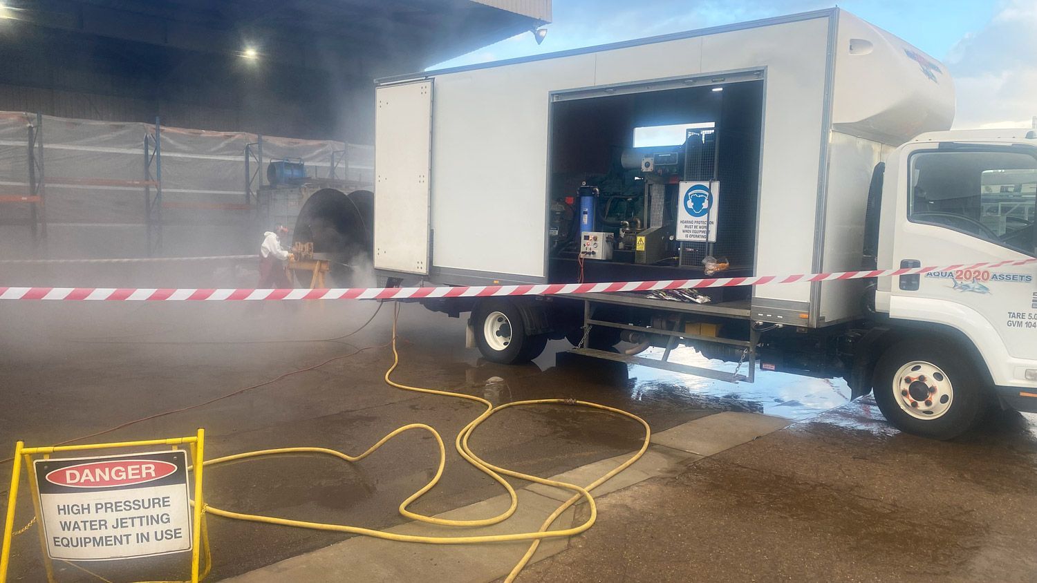 The Aqua Assets high pressure water jetting (hpwj) truck at an industrial complex.