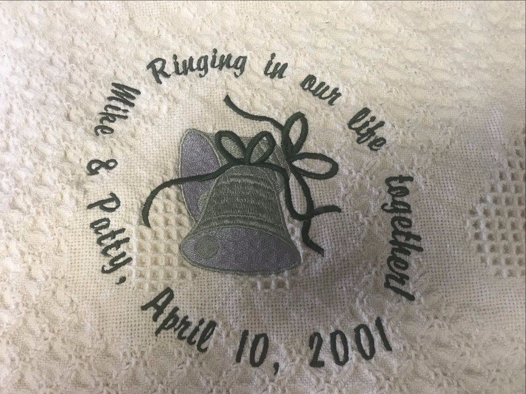 Embroidered wedding memento with two bells, the text 