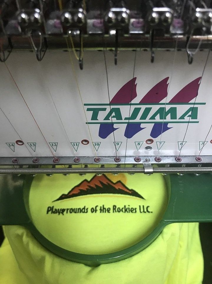 A Tajima embroidery machine stitching the 