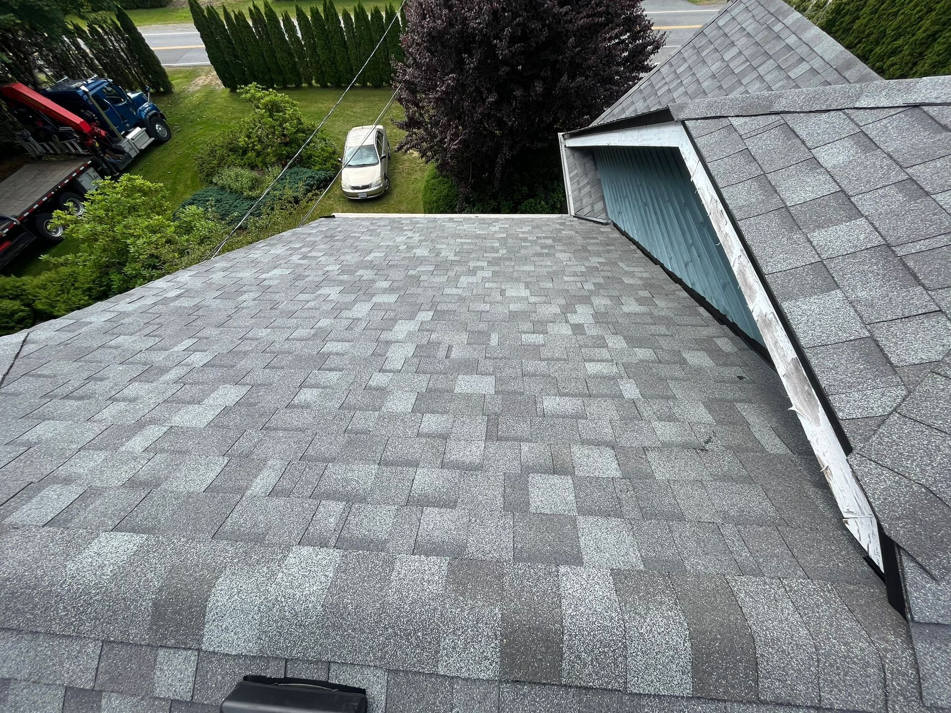 A car is parked on the roof of a house.
