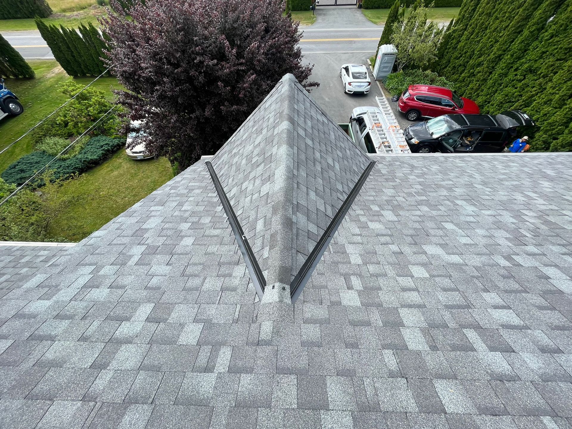 The roof of a house with a pyramid shaped roof.