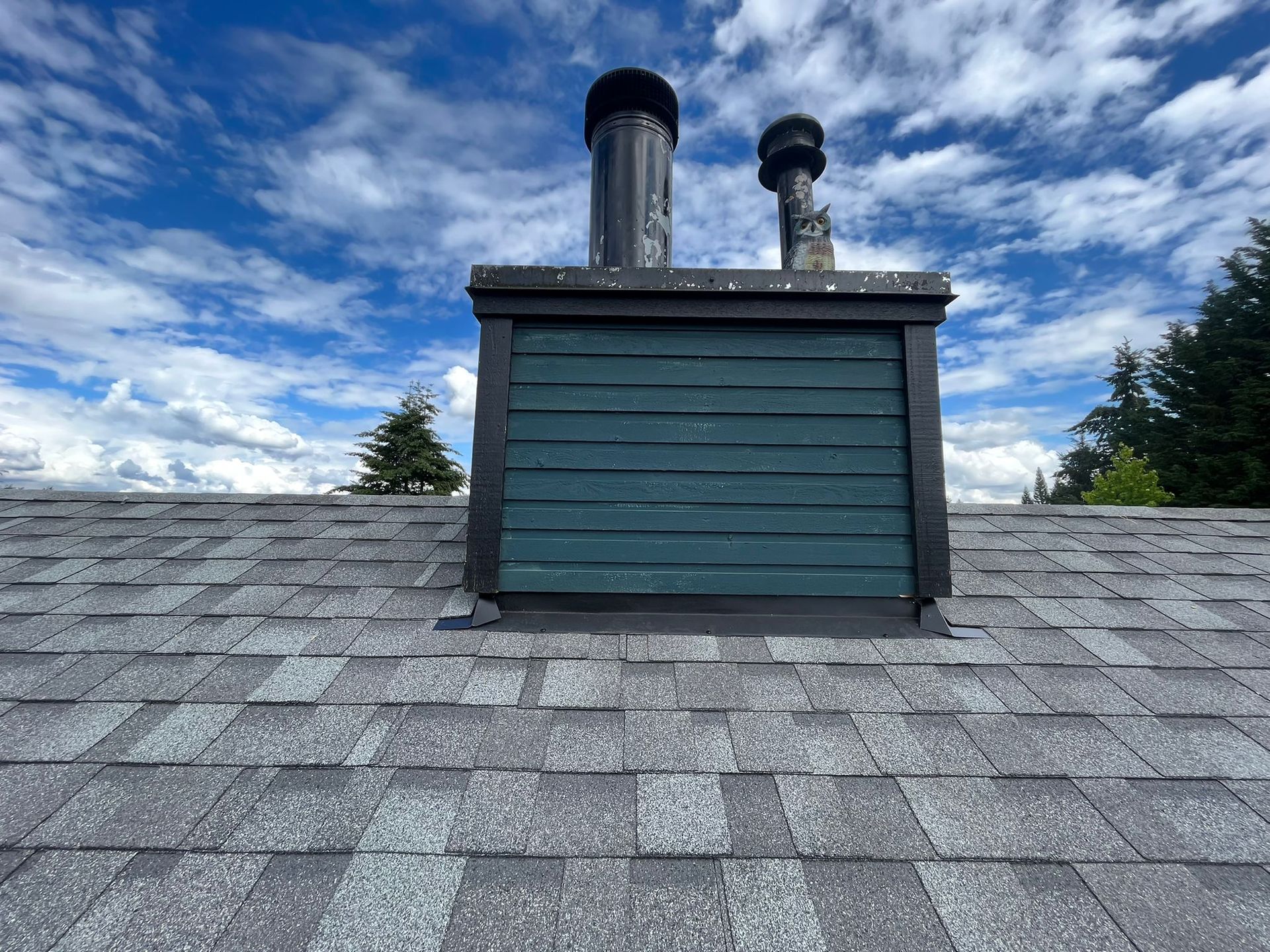 There is a chimney on the roof of a house.