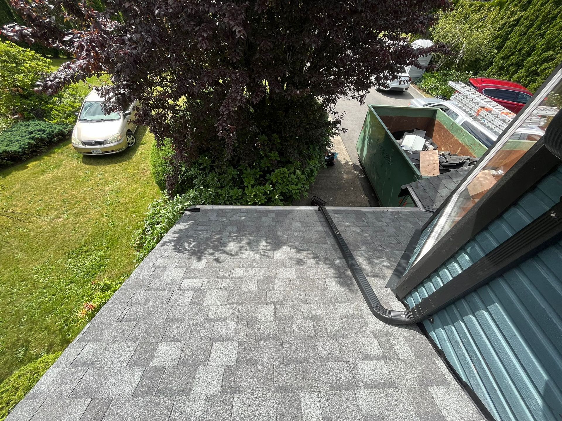 An aerial view of a roof with a car parked on the side of it.