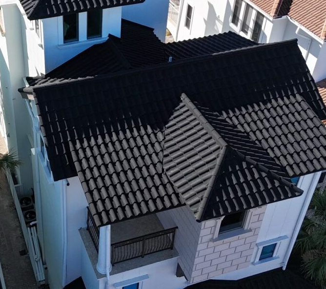 A roof with a vent on it and a building in the background.