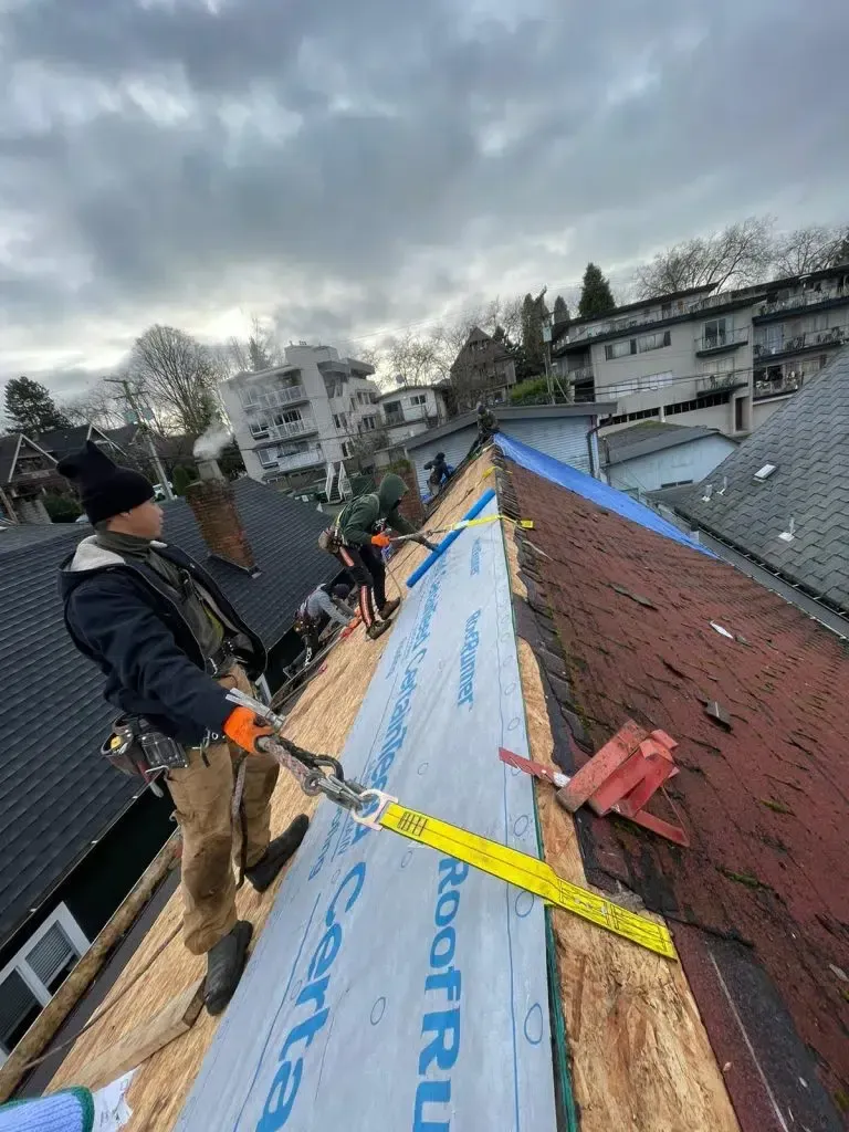 vancouver roofing contractor is working on the roof of a house.