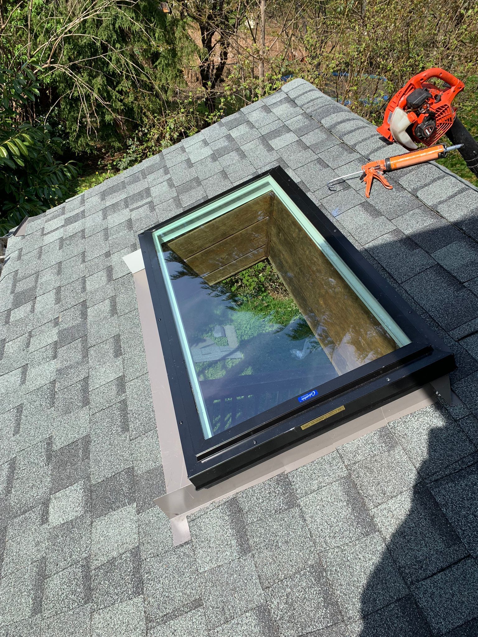 A skylight is sitting on top of a roof.