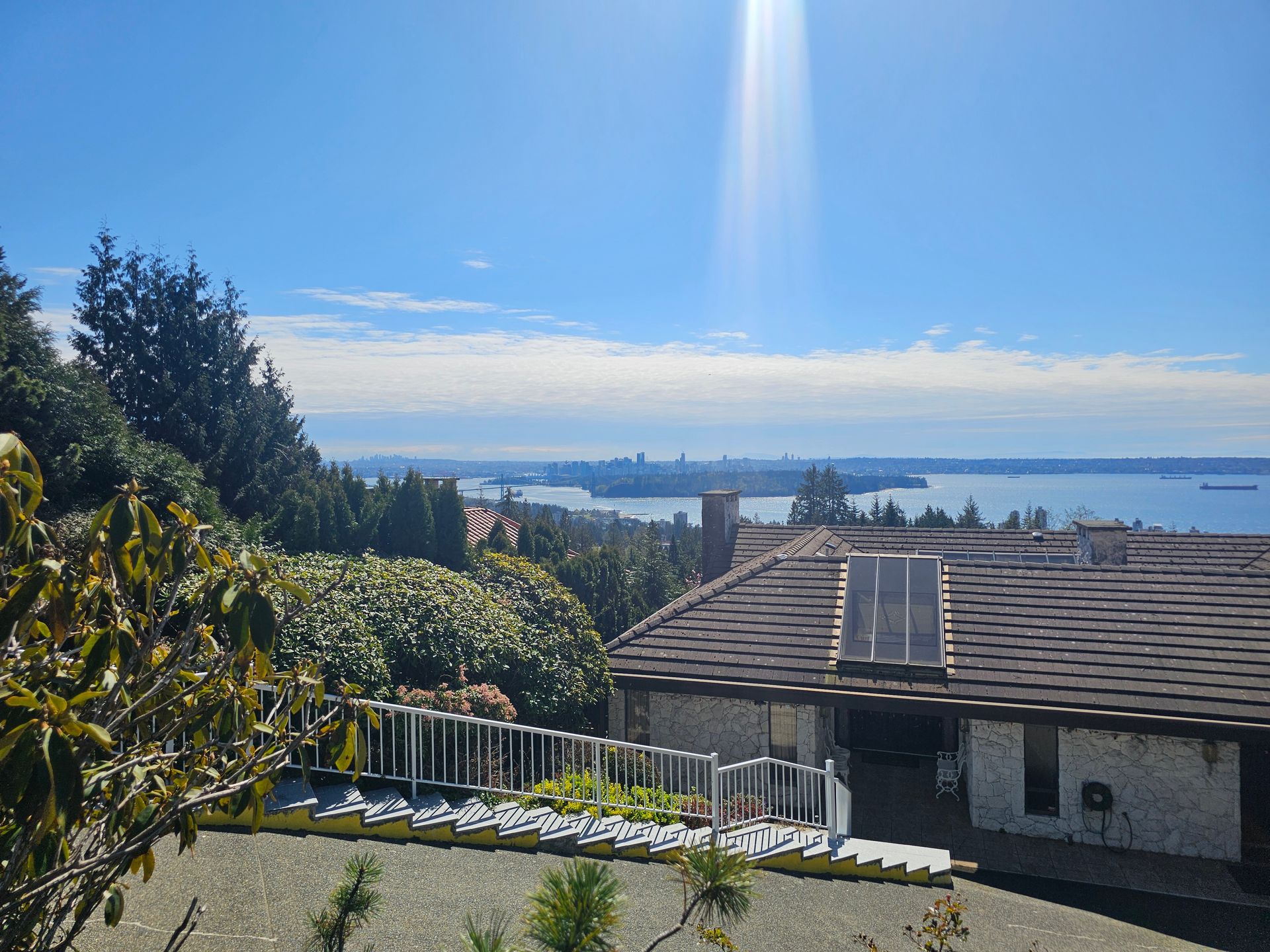 A house on a hill overlooking a body of water