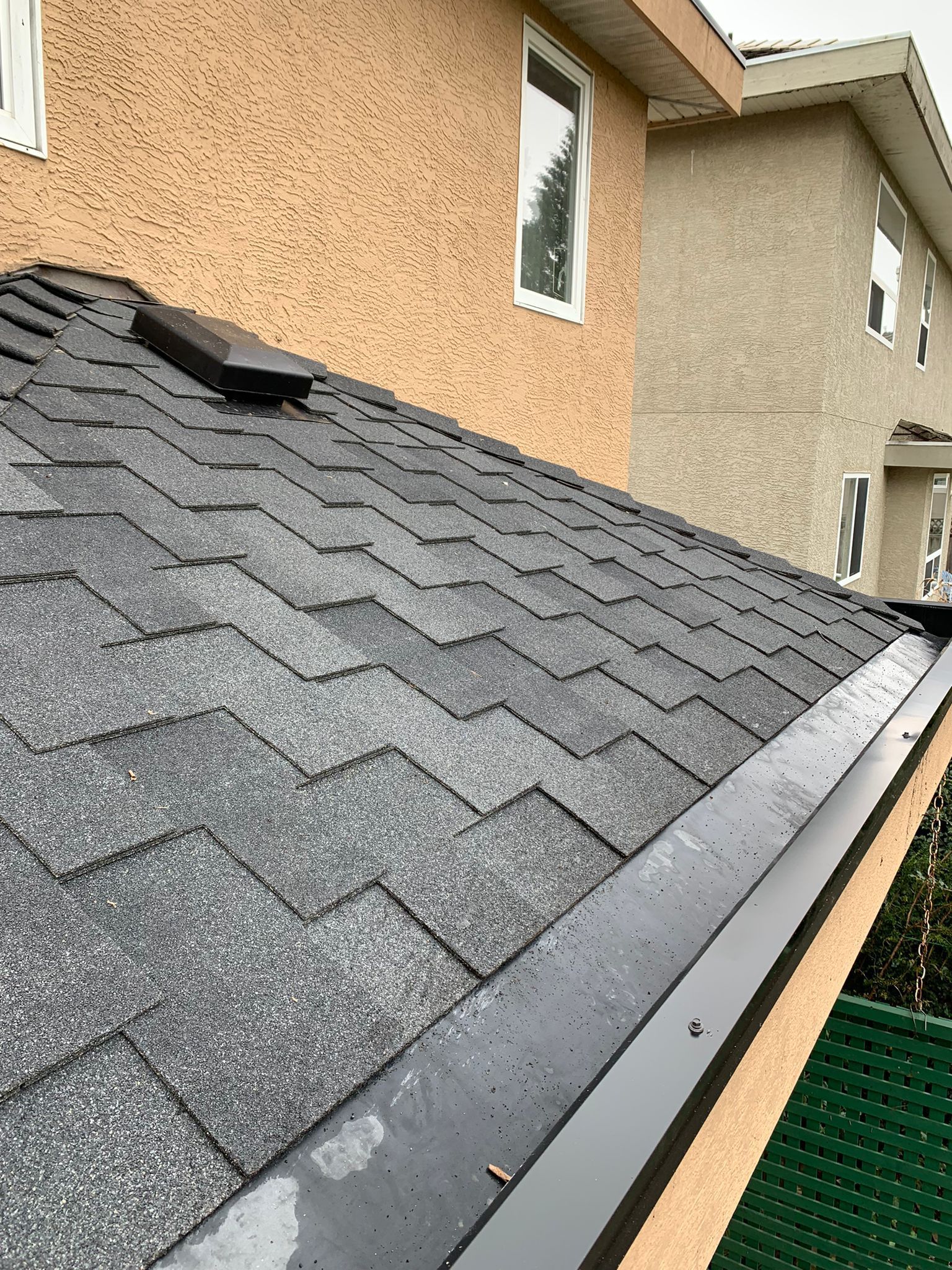 A close up of a roof with shingles on a house.