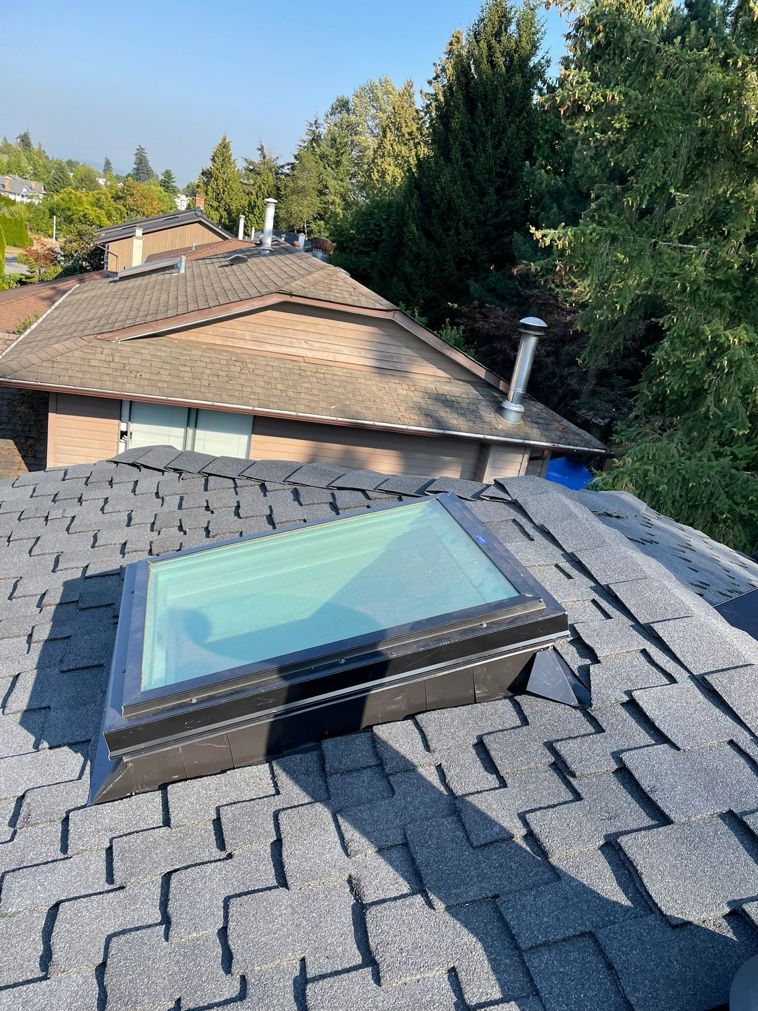 There is a skylight on the roof of a house.