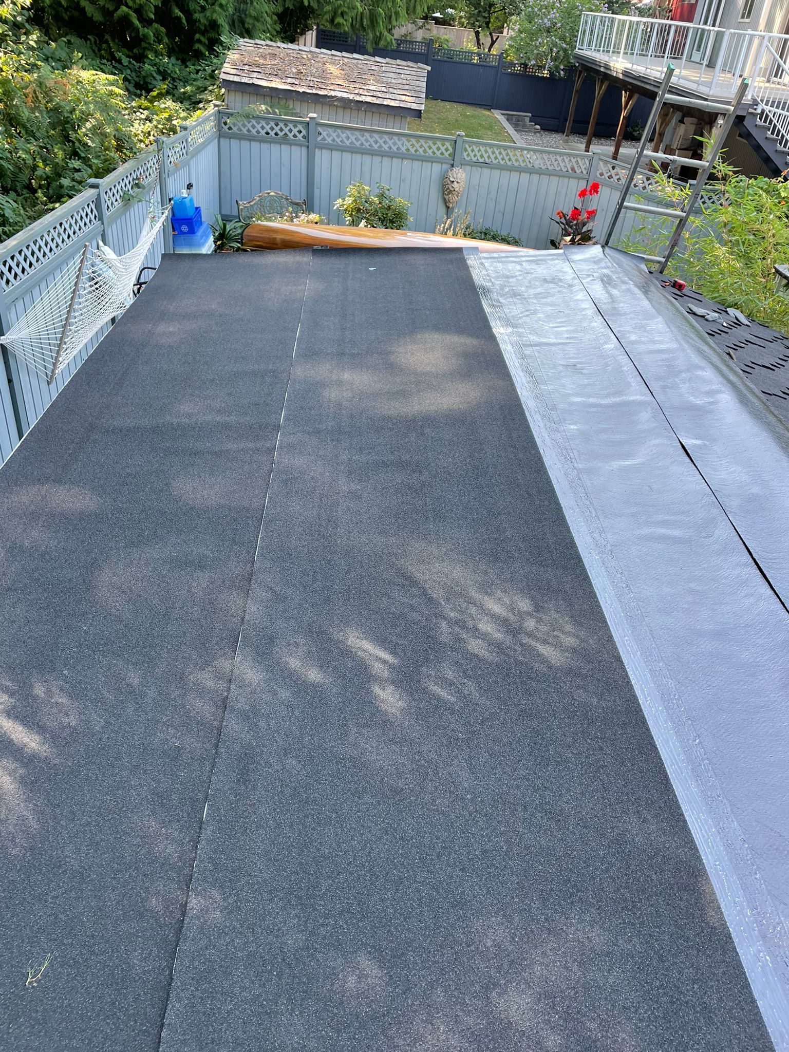 A staircase leading up to a house with a fence in the background.