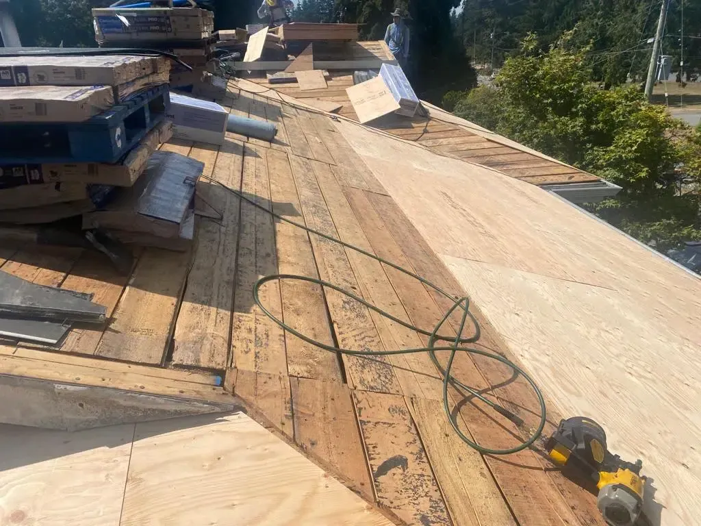 A roof is being built with wood and a drill.