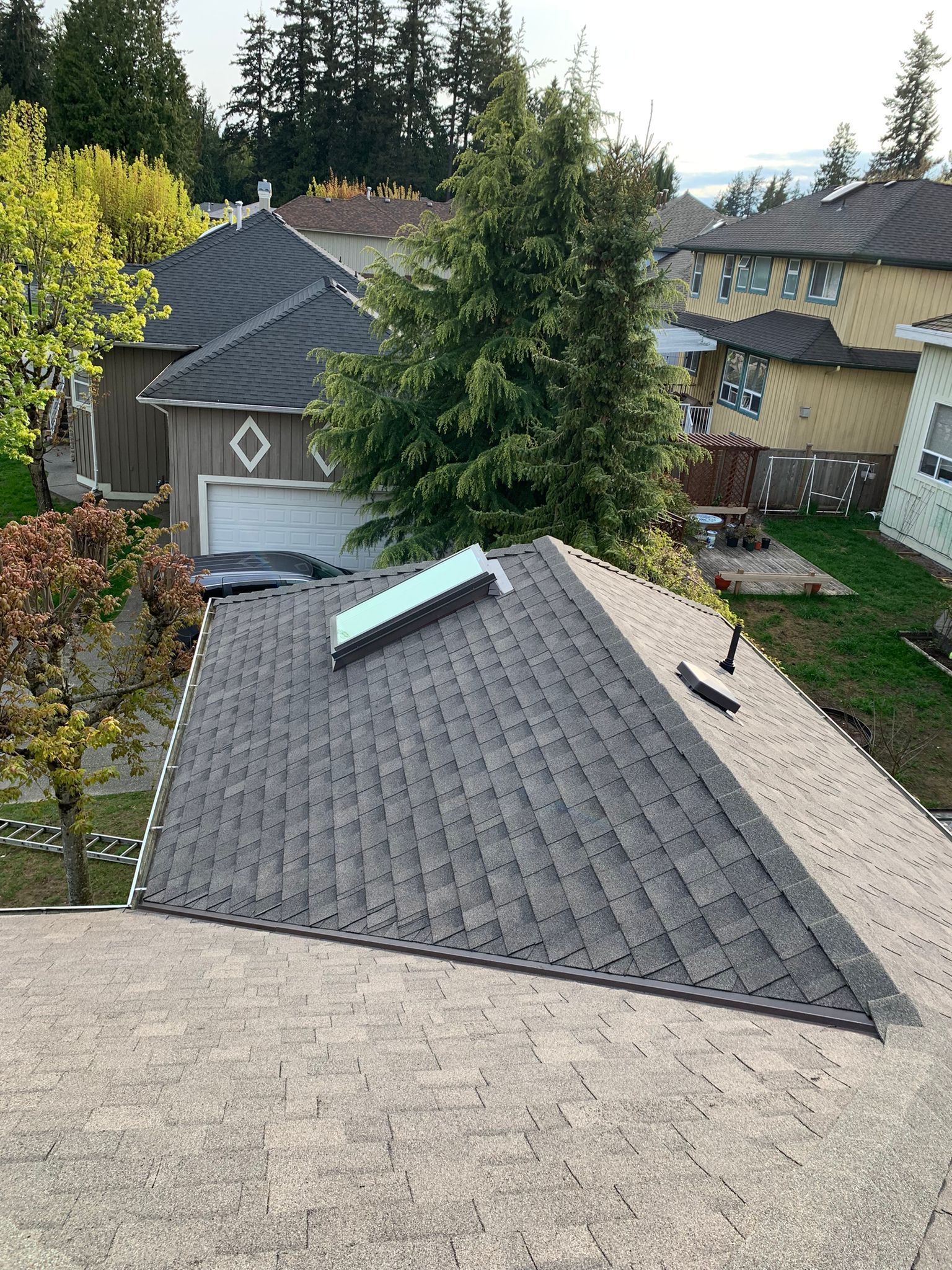 An aerial view of a roof with a solar panel on it.