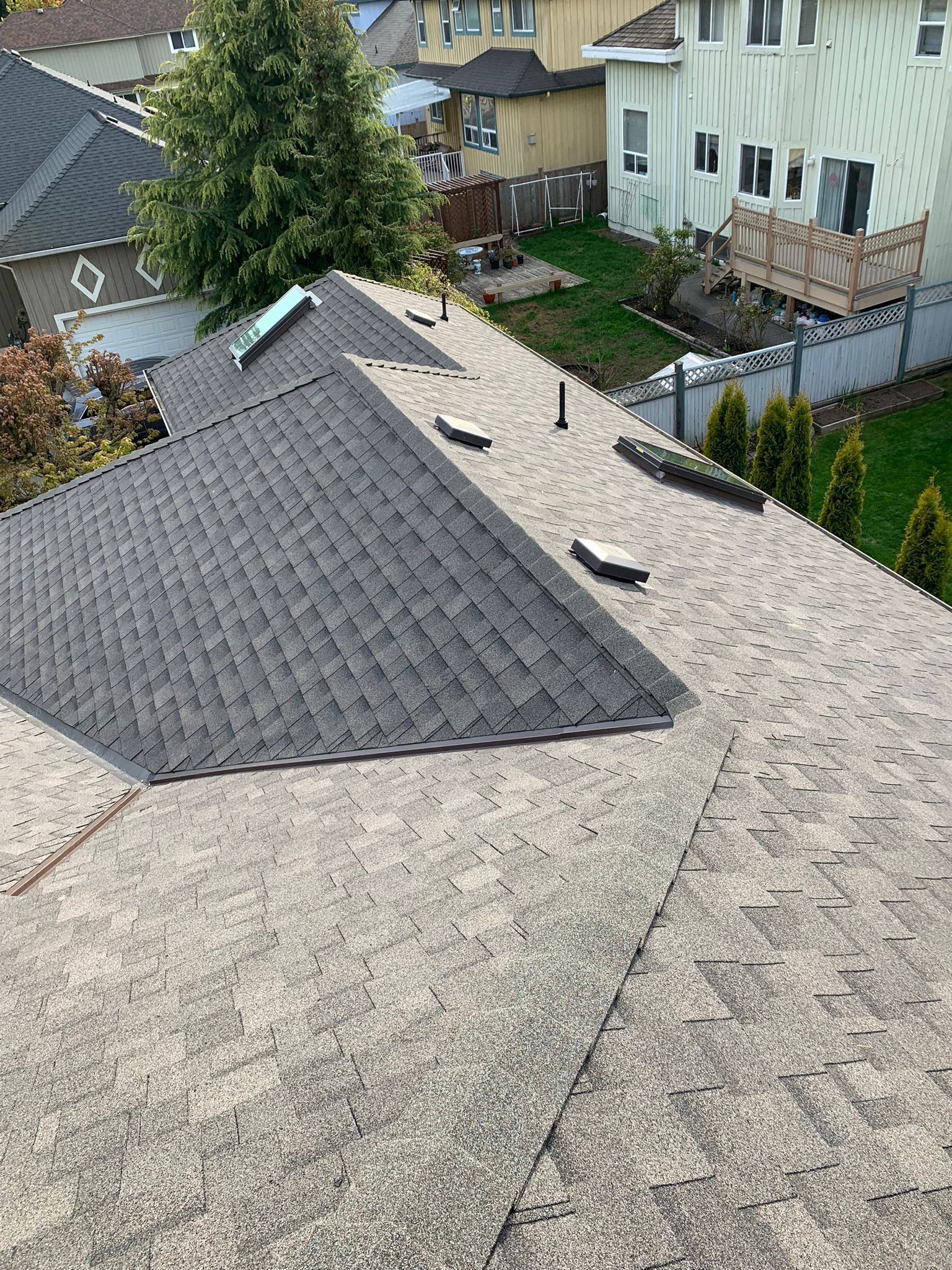 An aerial view of a roof of a house with a skylight.