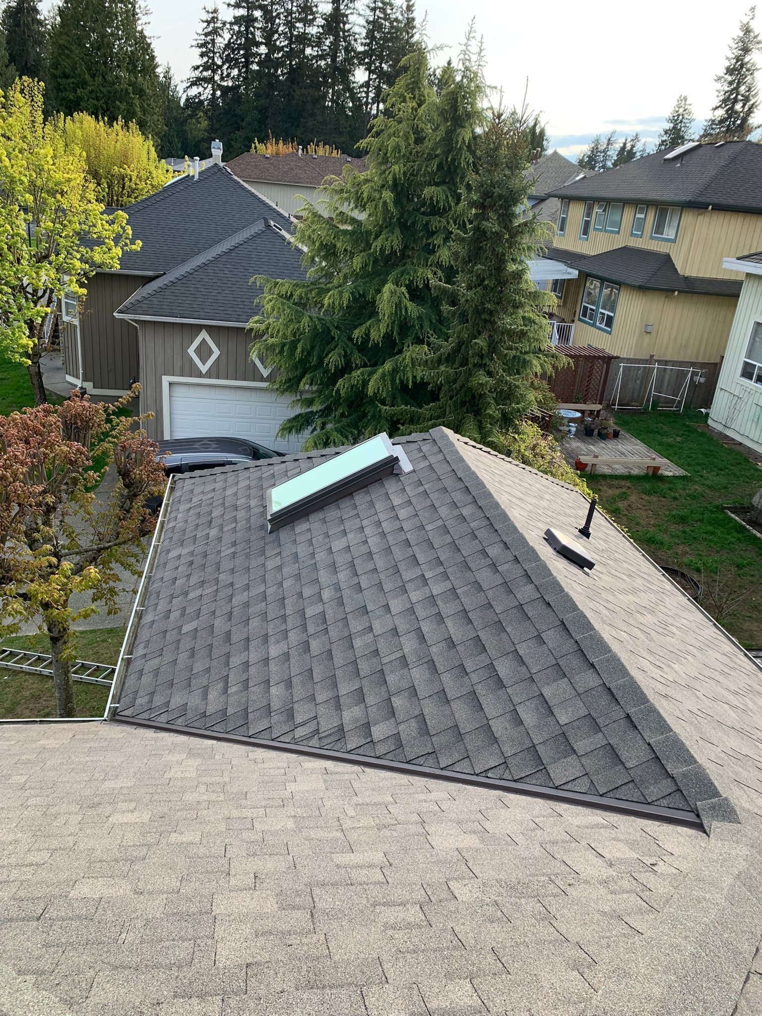 An aerial view of a roof with a skylight on it.