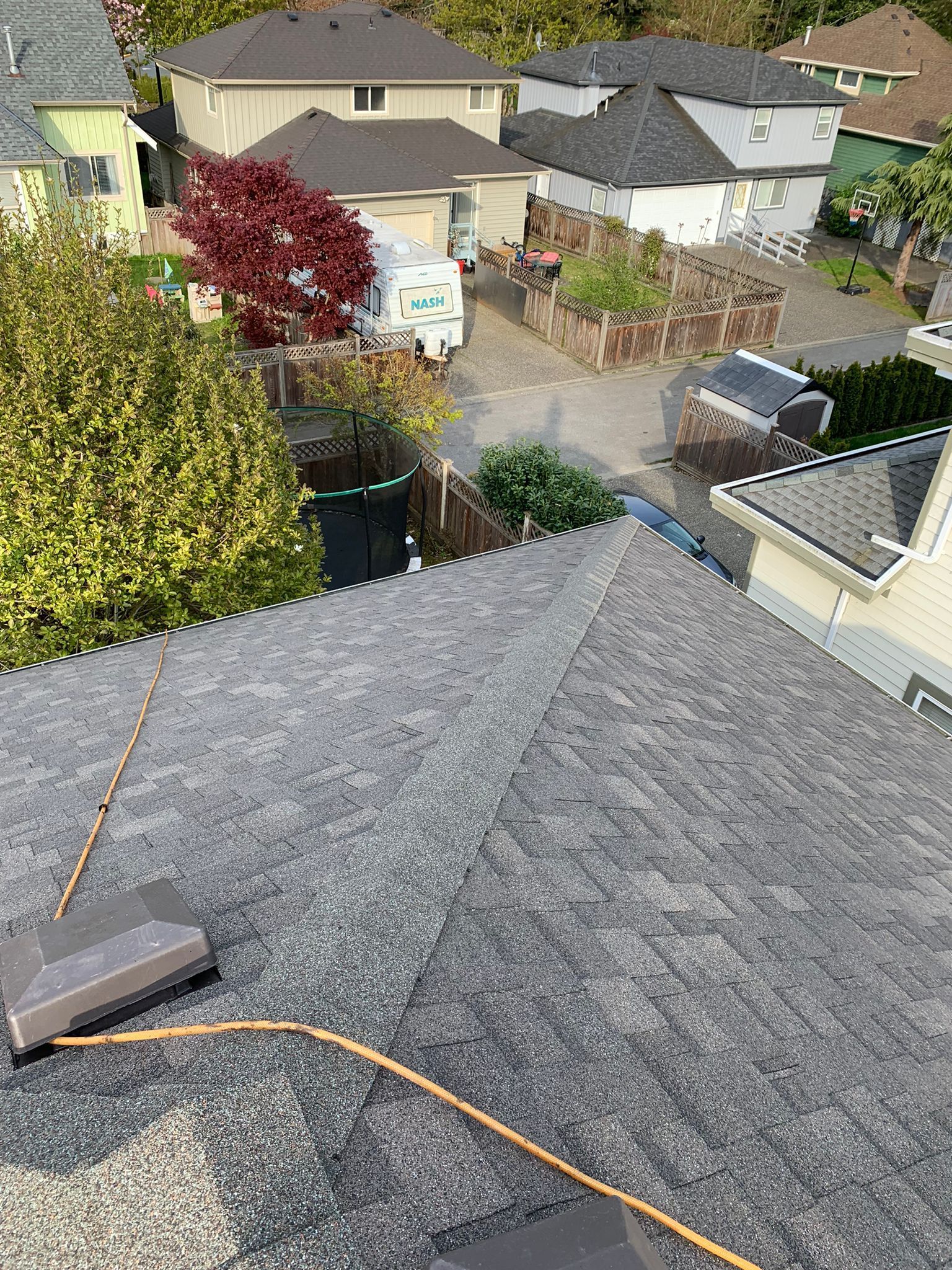 An aerial view of a roof with a power cord attached to it.